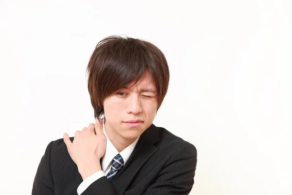 Young Japanese businessman suffers from neck ach — Stock Photo, Image