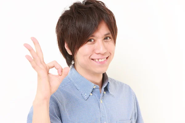 Young Japanese man showing perfect sign — Stock Photo, Image