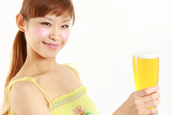 Young Japanese woman with a glass of beer — Stock Photo, Image