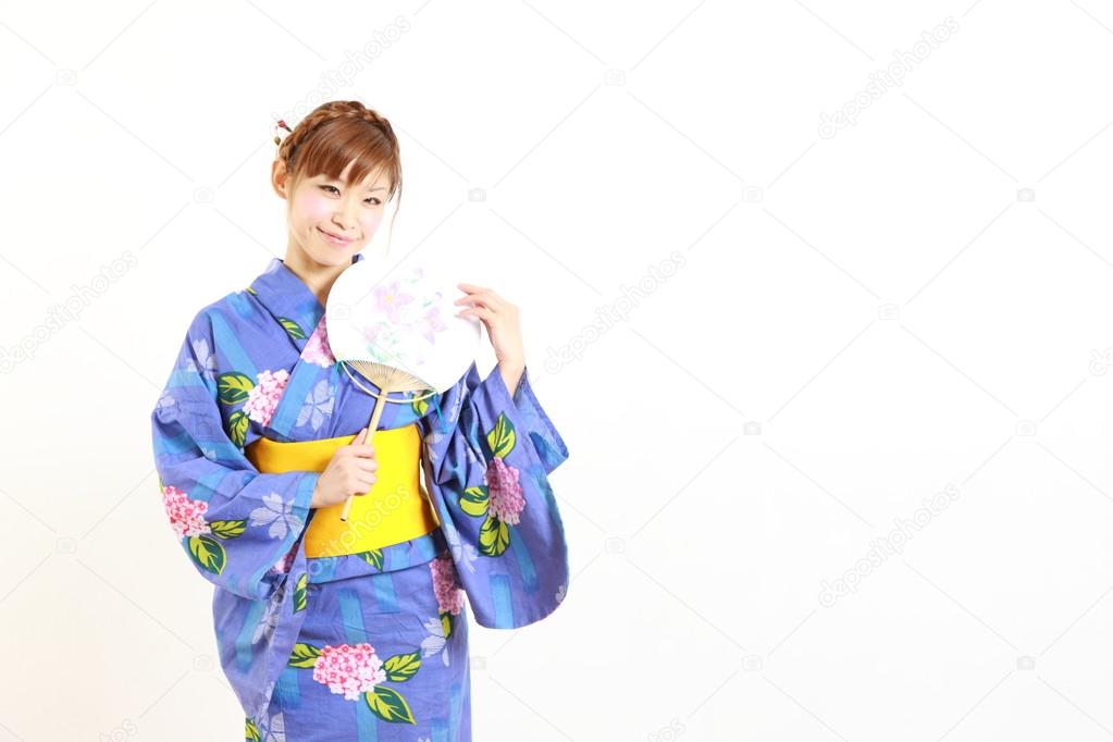 Young woman wearing Japanese kimono with paper Fan