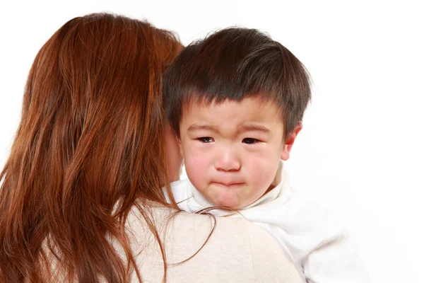 Crying Japanese little boy who is being held by her mother — Stock Photo, Image