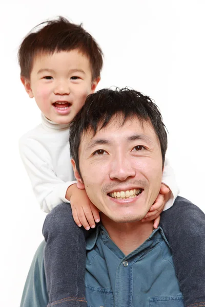 Japanese father giving his son piggy back — Stock Photo, Image