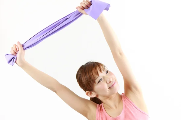 Young Japanese woman doing stretch bands exercise　 — Stock Photo, Image