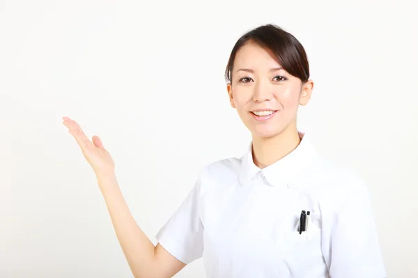 Young Japanese nurse explains — Stock Photo, Image