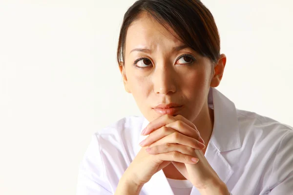 Young Japanese female doctor worries about something　 — Stok fotoğraf