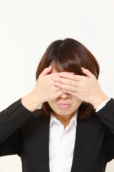 Portrait of covering her face with hands against white background — Stock Photo, Image