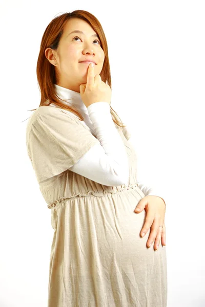 Těhotná žena si myslí, že o něčem — Stock fotografie