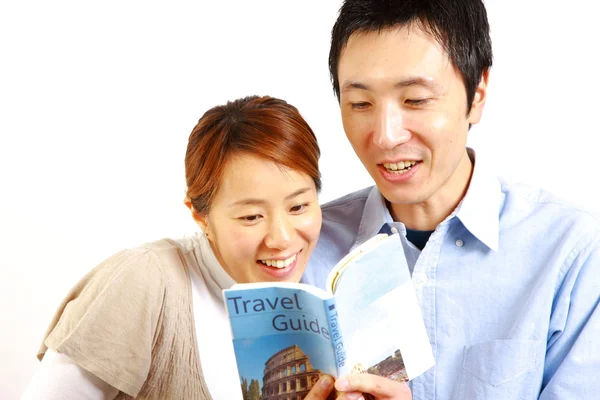 Young happy couple planning a travel — Stock Photo, Image