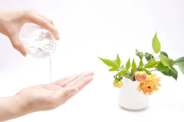 Applying skin lotion to hands — Stock Photo, Image