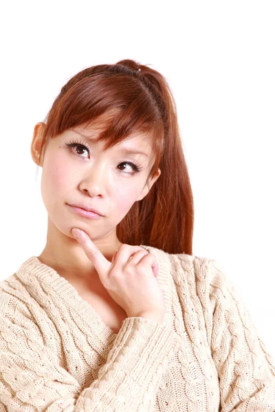 Japanese young woman thinks about something — Stock Photo, Image