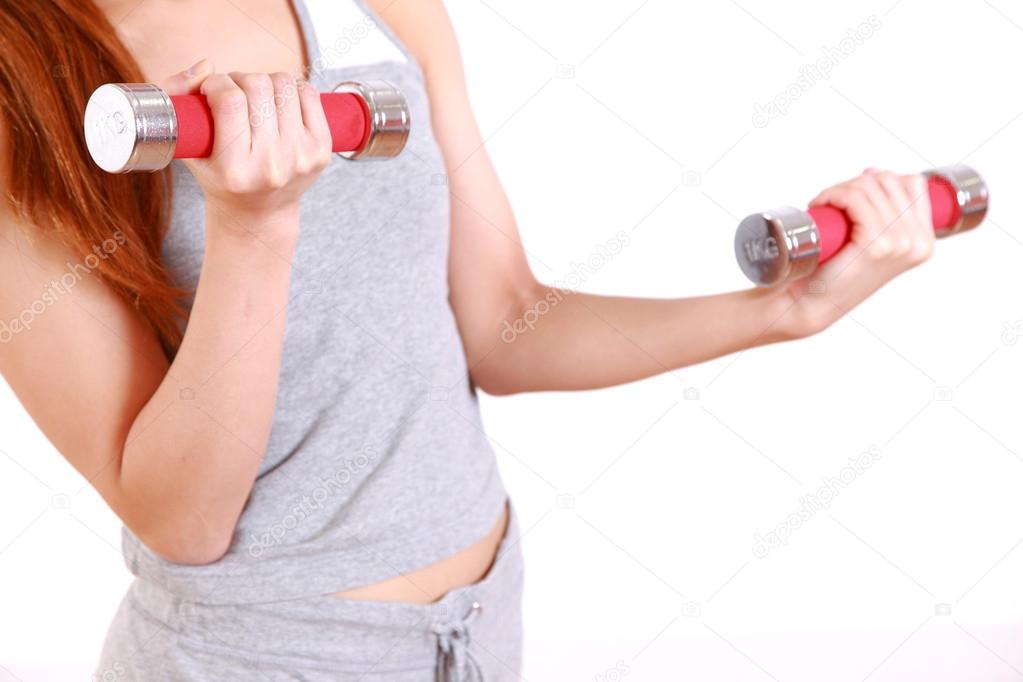 Young woman doing dumbbell exercise