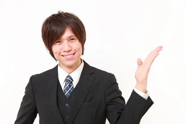 Japanese man presenting and showing something — Stock Photo, Image