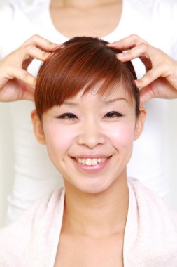 Young Japanese woman getting a head massage　