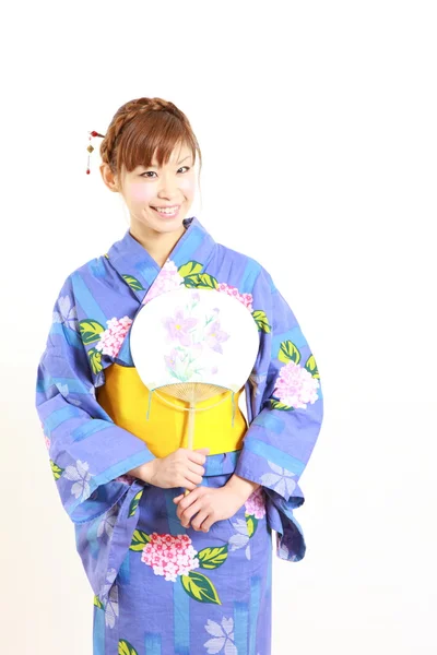 Young woman wearing Japanese kimono with paper fan — Stock Photo, Image