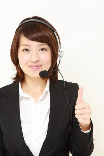 Zakenvrouw van callcenter met Duimschroef opwaarts gebaar — Stockfoto
