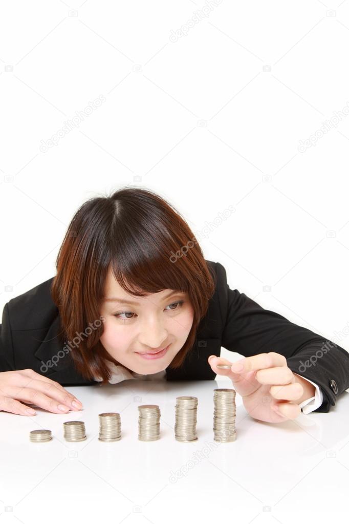 Businesswoman Put Coins To Stack Of Coins