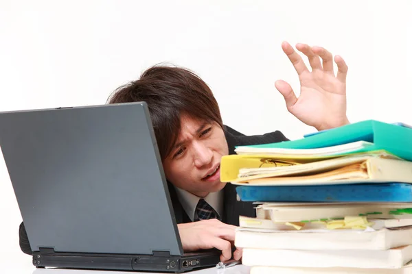 Businessman shrinks from overtime work — Stock Photo, Image