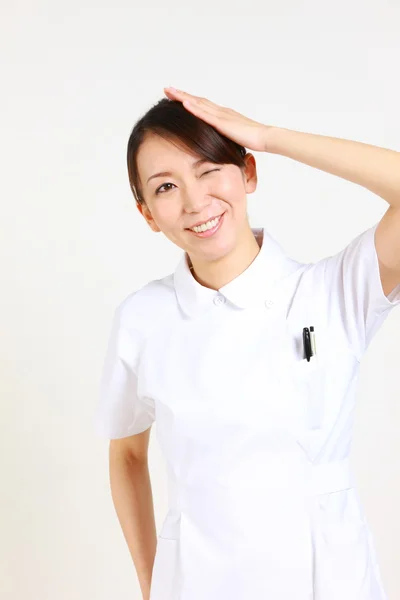 Young Japanese nurse reflects — Stock Photo, Image