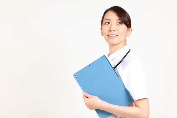 Young Japanese nurse with clinical record　 — Stock Photo, Image