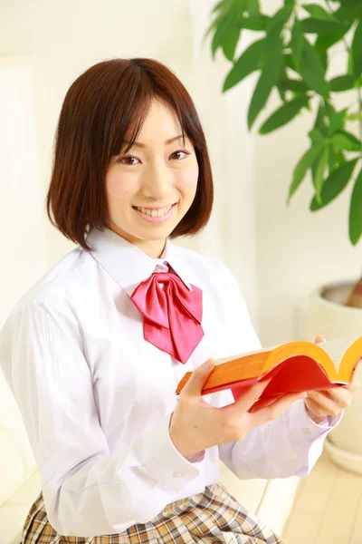 Female high school student with a book — Stock Photo, Image