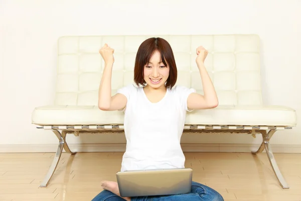 Young Japanese woman with computer pleased　 — Foto Stock