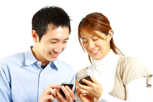 Japanese couple with smart phone — Stock Photo, Image