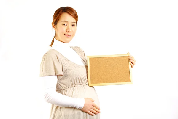 Pregnant woman with massage board — Stock Photo, Image