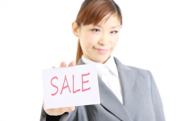 Businesswoman showing a card with word  SALE — Stock Photo, Image