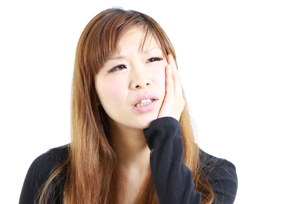 Young Japanese woman suffers from toothache — Stock Photo, Image