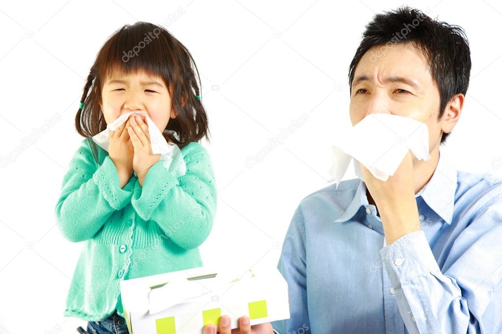 Sneezing father and daughter