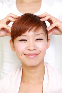 Young Japanese woman getting a head massage　