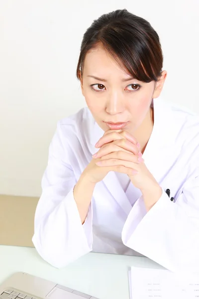 Young Japanese female doctor worries about something — Stock Photo, Image