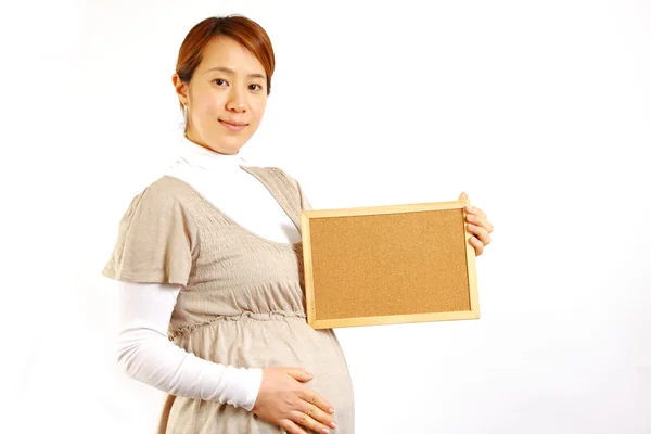 Pregnant woman with massage board — Stock Photo, Image