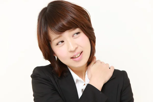 Japanese businesswoman suffers from neck ache — Stock Photo, Image