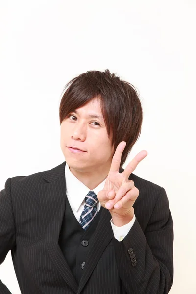 Young Japanese Businessman showing a victory sign — Stock Photo, Image