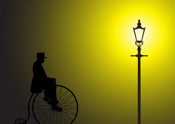 Penny Farthing caballero en la luz de la calle — Archivo Imágenes Vectoriales