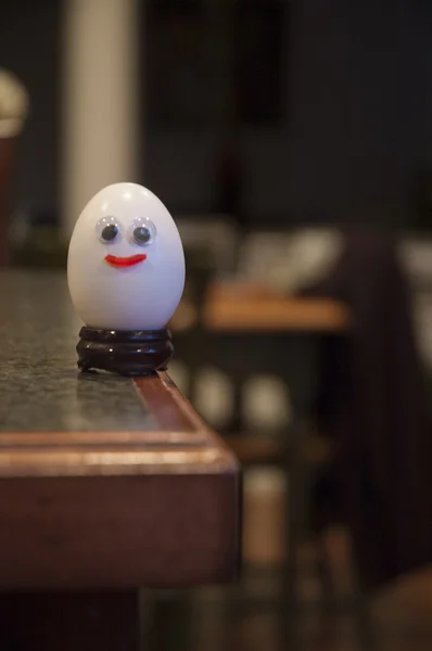 Happy Smiling Egg on the Edge of a Table