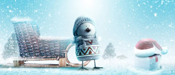 Happy snowman standing in winter christmas landscape.