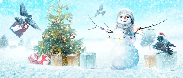 Happy snowman standing in winter christmas landscape.