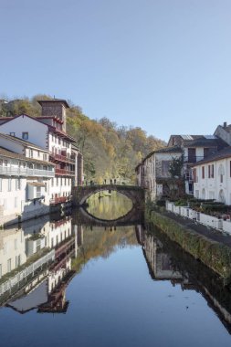 Saint Jean Pied de Port with the Old bridge over the river Nive and the houses along the river in the Basque Country, Spain