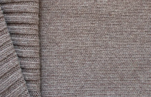 Seamless knitted fabric with pigtails. Knitted sweater, plaid, scarf. Knitted background