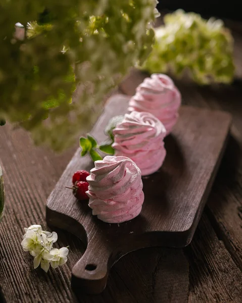 Handmade pink marshmallows on parchment background. Marshmallow, Meringue. Homemade Sweets dessert Women hand
