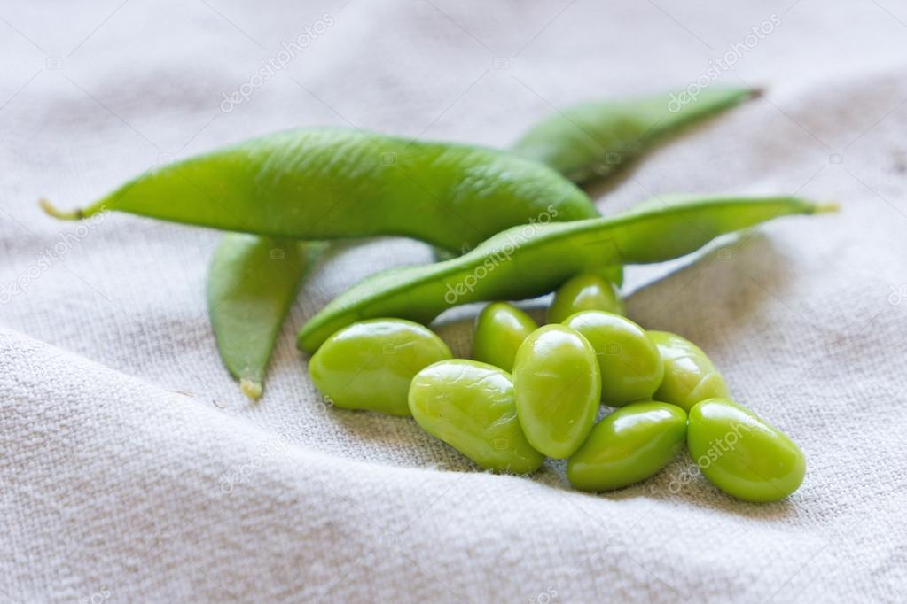 Boiled green soybeans on fabric background