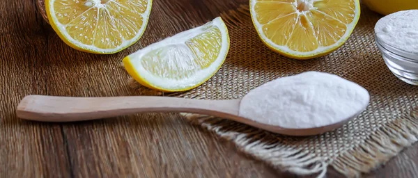 Citric acid on a wooden background with lemon. Selective focus.food
