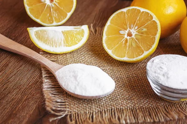 Citric acid on a wooden background with lemon. Selective focus.food