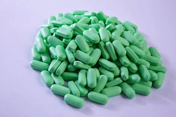 Vitamin tablets used as a dietary supplement.green tablets..selective focus.medical