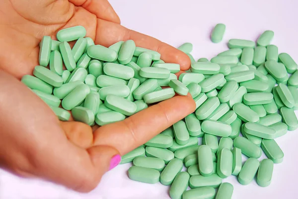 Vitamin tablets used as a dietary supplement.green tablets..selective focus.medical
