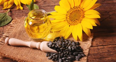 Eski ahşap arka planda ayçekirdeği ve yağ şişesi. Seçici odaklanma. Doğa.