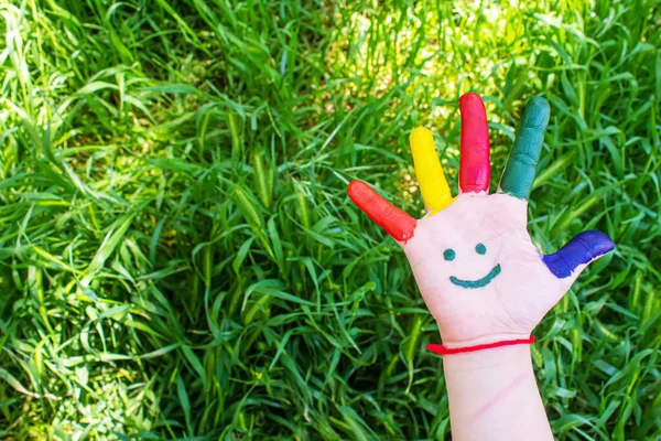 Children\'s hands in the colors of summer. Selective focus.nature