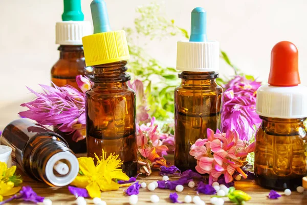 Medicinal herbs, oils in small bottles homeopathy. selective focus. — Stock Photo, Image